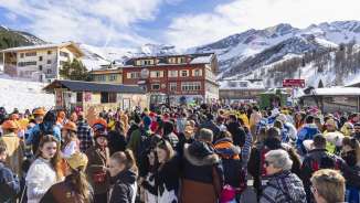 People in fancy dress celebrate the carnival parade in snowy Malbun, Liechtenstein.
