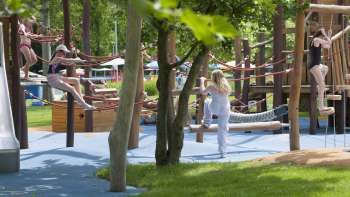  Colorful tables and chairs in the Mühleholz outdoor pool restaurant - ideal for relaxing after a swim.