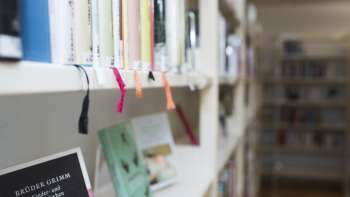 Close-up of a bookshelf with colored ribbon markers in the National Library in Vaduz.