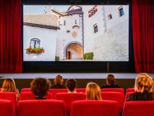 Visitors to the old cinema in Vaduz watch a movie with footage from Liechtenstein