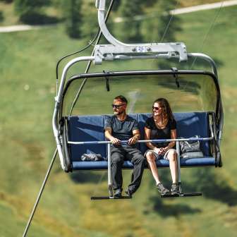 Couple takes the chairlift to Sareis
