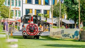 Citytrain through Vaduz on green artificial turf at the Summer Gathering in Vaduz