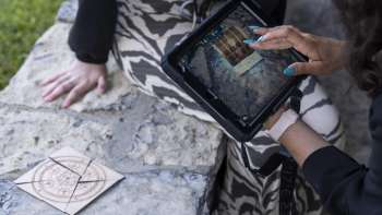 Player uses iPad to solve puzzles in the Outdoor Adventure Room