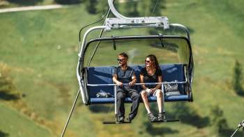 Couple takes the chairlift to Sareis