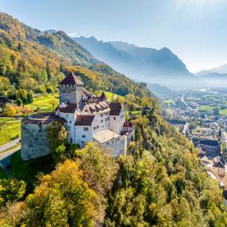 Autumnal view of Vaduz Castle in Liechtenstein with a view over the Rhine Valley