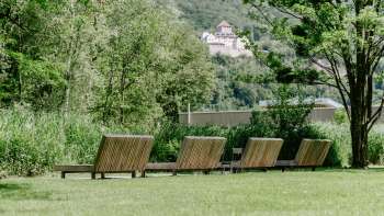 Lawn with wooden loungers with a view of Vaduz Castle