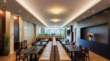 Bright dining room in the Kommod restaurant with stylish design and large windows.