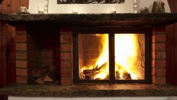 Warm fireplace with burning wood and atmospheric light