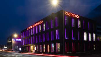 The Casino Schaanwald in the dark, impressively illuminated with purple light accents - a popular destination for night owls in Liechtenstein.