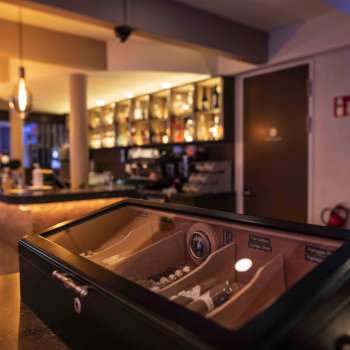cozy bar in the Casino Admiral Triesen with elegant lighting and a large selection of drinks.
