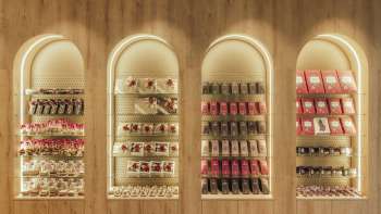 Decorative wall shelf with stylishly arranged boxes of chocolates and fine treats