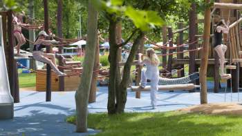 Colorful tables and chairs in the Mühleholz outdoor pool restaurant - ideal for relaxing after a swim.