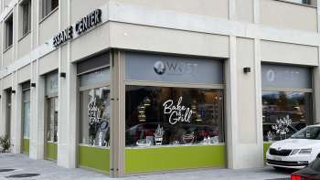 Exterior view of the Wüst bakery in Eschen with large shop windows and modern signage