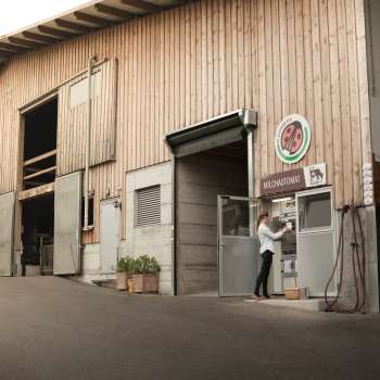 Exterior view of the Kaiserhof in Liechtenstein with self-service milk filling station - regional, fresh and direct from the farm.
