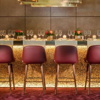 Elegantly decorated bar with modern chairs, glasses and candlelight at the Park Hotel Sonnenhof in Vaduz, Liechtenstein