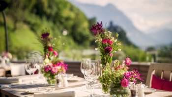 Atmospheric table setting with white napkins, glasses and cutlery in a modern ambience