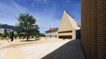 View of the brightly paved Peter-Kaiser-Platz in front of the parliament building in Vaduz with its modern architectural ensemble.