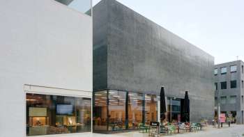 Exterior view of the Liechtenstein Art Museum with modern façade and café terrace in Vaduz.