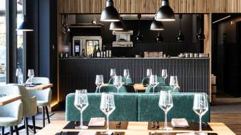 Cozy dining room with relaxed seating arrangement, modern furniture and creative wall design