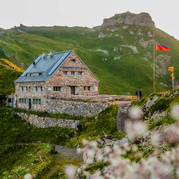 Close-up of the Pfälzer hut with Liechtenstein flag in the evening.