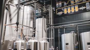 Technical detail of a brewing process with pipelines, tanks and diagram of beer production.
