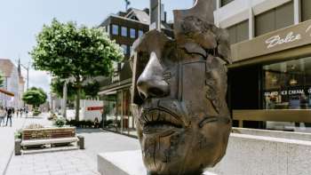 Bronze sculpture "African King" by Gunther Stilling with an abstract male head in the pedestrian zone of Vaduz.