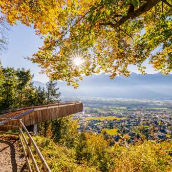 Viewing platform in the golden fall light with a view of Vaduz and the surrounding countryside
