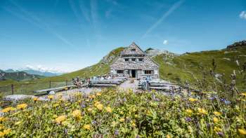 Mountain hikers on their way to Pfälzerhütte hut, nestled in alpine surroundings