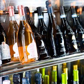 Well-stocked wine fridge with a selection of red, white and rosé wines at Dolce Gusto