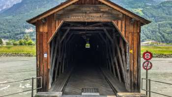 Entrance to the Old Rhine Bridge Vaduz-Sevelen - listed wooden bridge as a foot and cycle path between Liechtenstein and Switzerland.