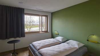 Twin room with green-painted wall in Schaan/Vaduz Youth Hostel