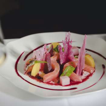 Close-up of a gourmet plate with fresh ingredients, bright colors and creative plating