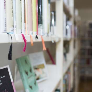 Close-up of a bookshelf with colored ribbon markers in the National Library in Vaduz.