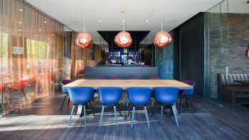 Modern restaurant with stylish interior, blue designer chairs and elegant bar in the b_smart hotel