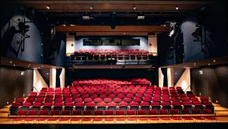 View from the stage of red rows of seats and lighting technology in the modern auditorium of the TAK Theater Liechtenstein