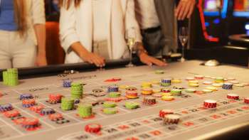 Guests at the gaming table placing their chips at Casino Admiral Triesen, surrounded by an exciting casino atmosphere.