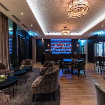 Cozy bar with stylish lighting and a selection of spirits.