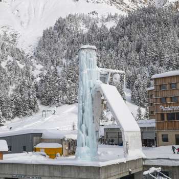 View of the ice tower in Malbun with snow-covered forest in the background