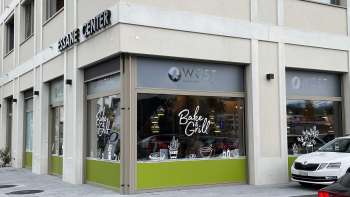 Exterior view of the Wüst bakery in Eschen with large shop windows and modern signage