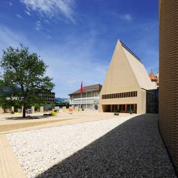 View of the brightly paved Peter-Kaiser-Platz in front of the parliament building in Vaduz with its modern architectural ensemble.