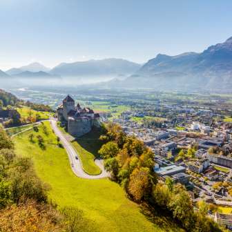Aerial view of Vaduz Castle with a view over the city of Vaduz and the Rhine Valley on a clear fall day