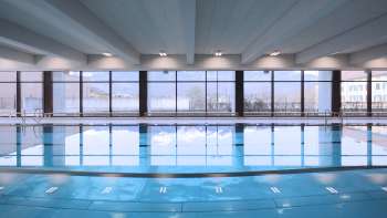 View of the blue swimming pool in the Triesen indoor pool