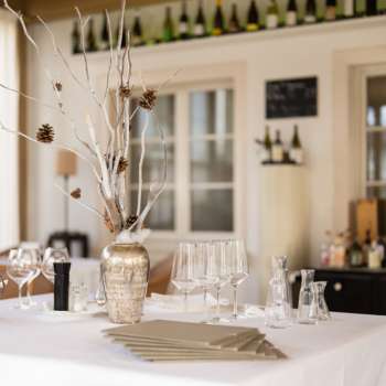 Decorative bar in the Vivid restaurant with stylish glasses, bottles and natural mood lighting