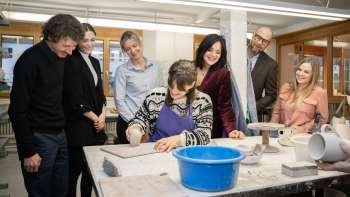 A group of interested visitors watch a potter modeling - a creative experience in a cozy atmosphere at the Schädler ceramics workshop in Nendeln.