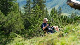Wheelchair user enjoys the alpine landscape in Malbun - barrier-free access to nature in Liechtenstein