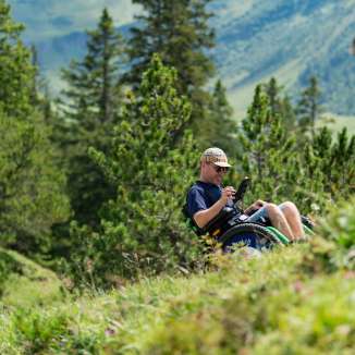 Wheelchair user enjoys the alpine landscape in Malbun - barrier-free access to nature in Liechtenstein