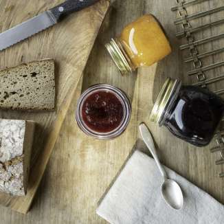 Fresh Holder jam with farmhouse bread and jam jars on a wooden board - enjoy a traditional breakfast in Liechtenstein