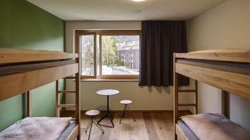 Bright shared room with a view from the window at the Schaan-Vaduz Youth Hostel