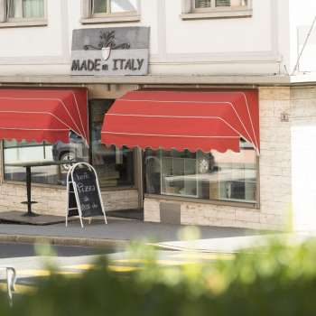 Exterior view of the Made in Italy restaurant with striking red awning in Vaduz.