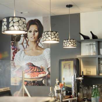 Bar area in Made in Italy with atmospheric lighting and Italian flair.